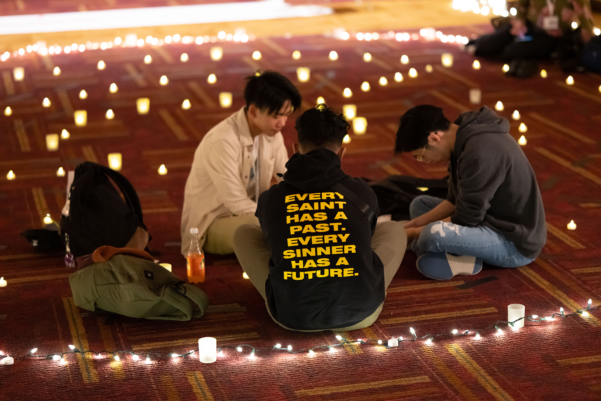 students seated in a prayer circle